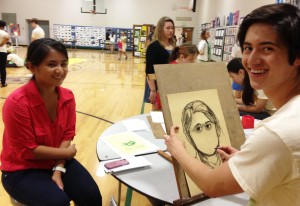 Senior Luke Ferguson draws portrait of Senior Maria Halaguena