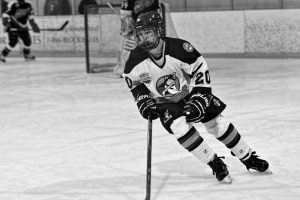 Ryan Allison skates to the puck during his ice hockey game (Photograph courtesy of Ryan Allison).