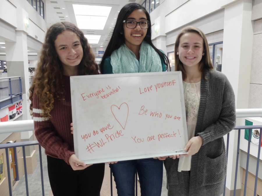 From left to right: Zoe Davidson, Seetal Ahluwalia,  and Sally Kulesza all write a positive message to share with others.