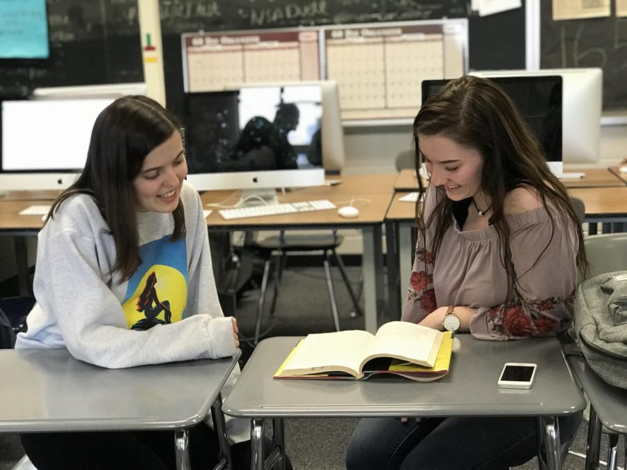 Jane Hilger and Savannah Jackson discuss a book during some free time. 