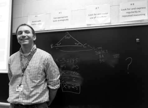 Mr. Damseaux smiles next to a math equation. 