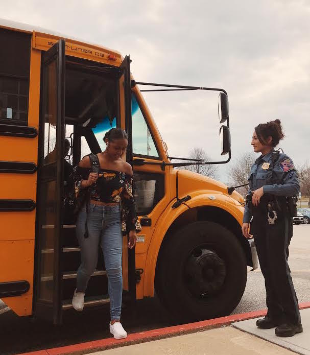 Senior+Darae+Lyles+gets+off+of+her+bus+to+be+greeted+by+Officer+Shams