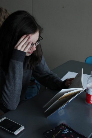 Wilde Lake junior, Sydney Lowry, stresses while reading a book written entirely in French. Photo by Preeta Singh. 