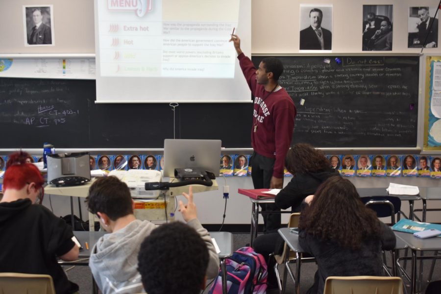 Mr. Press is pictured instructing his U.S History class in his Morehouse sweater that he pridefully showcases. 