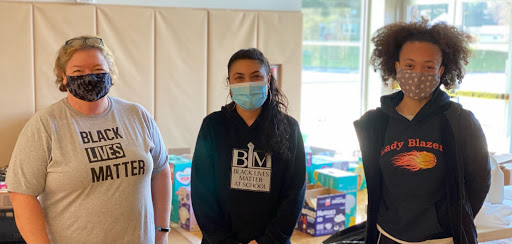 Meg Feroli (left), Erika Chavarria (middle), and Makenna Burns (right) working at one of the Ellicott City donation and distribution sites, December 2020