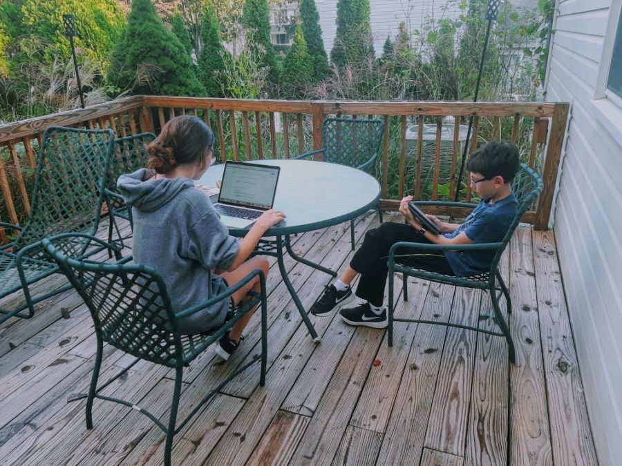 Sarah Rubin and her brother, Daniel, do homework outside together.