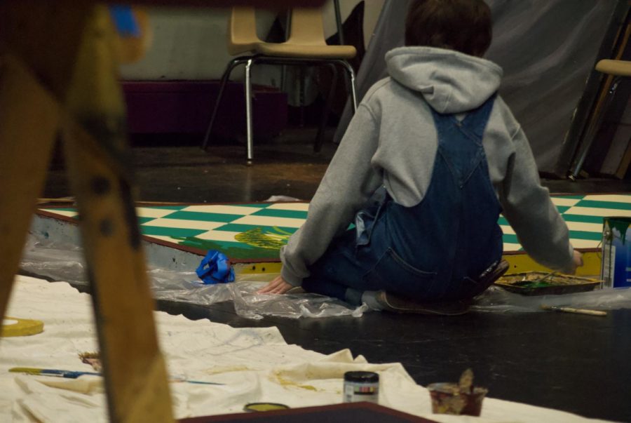 Felix Gomez painting one of the wood panels.