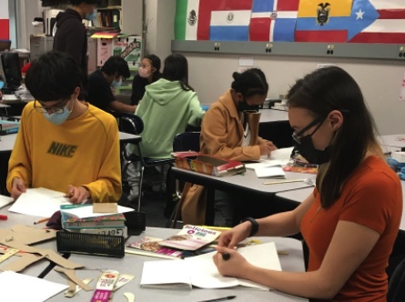 Thomas Dragovich (left) and Valerie Brady (right) binding notebooks after school. 