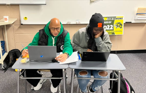 Mr. Bell helping junior Alaijah Reed-Wright with schoolwork.