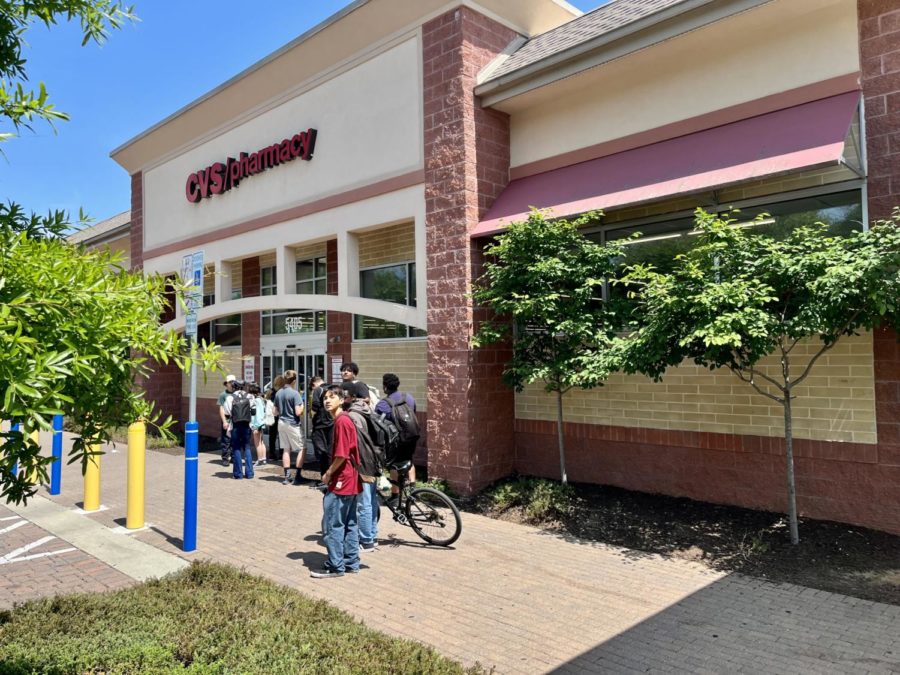 Students after school on May 30, 2023 waiting to get into CVS. Students wait in line in order for the store to maintain their number restriction. Three to four students are allowed inside at a time.