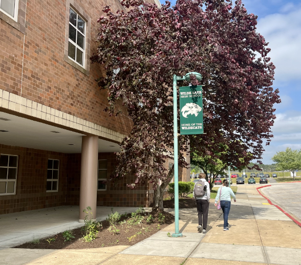 On May 30, 2023, two high schoolers walk past the native gardens in front of Wilde Lake during third period. 