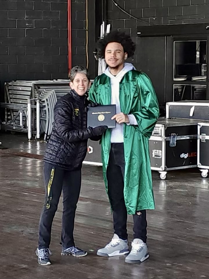 COLUMBIA, MARYLAND, February 29, 2024 -- Ms. Leonard and Angel Castro take a picture as he walks across the Merriweather stage.