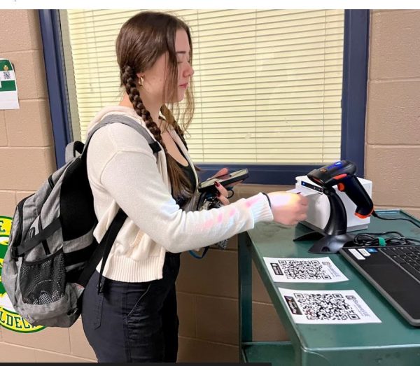 COLUMBIA, MARYLAND, FEBRUARY 23, 2024 -- Junior Autumn Wilkerson receives her late pass after scanning her Synergy QR code. According to administration, having students sign in with their QR codes provides more accurate data on student attendance.