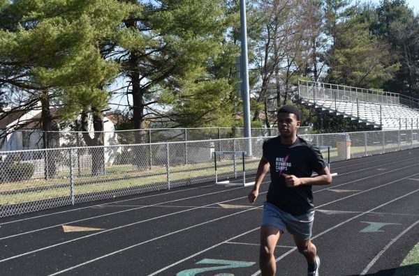 COLUMBIA, MARYLAND, MARCH 15, 2024 -- Senior track captain Emmanuel Dean runs laps during after school practice to train for the upcoming outdoor track season. 